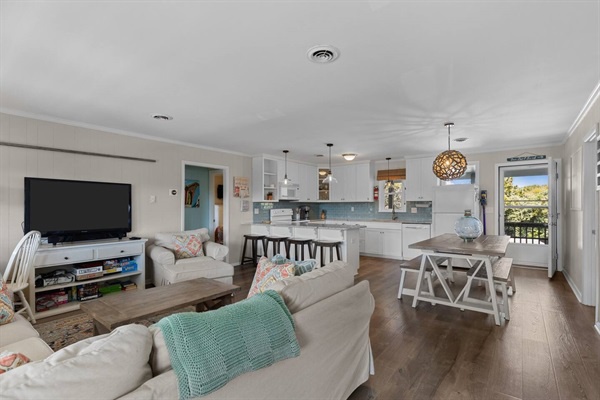 Your open-plan living space flows seamlessly from kitchen to dining, perfect for gathering with loved ones while enjoying meals together.