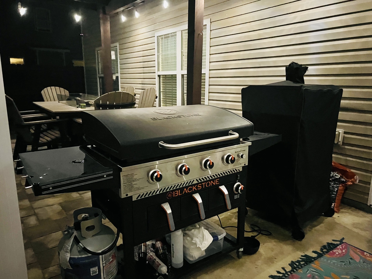 Fire up the Blackstone grill for your perfect outdoor feast under twinkling patio lights.