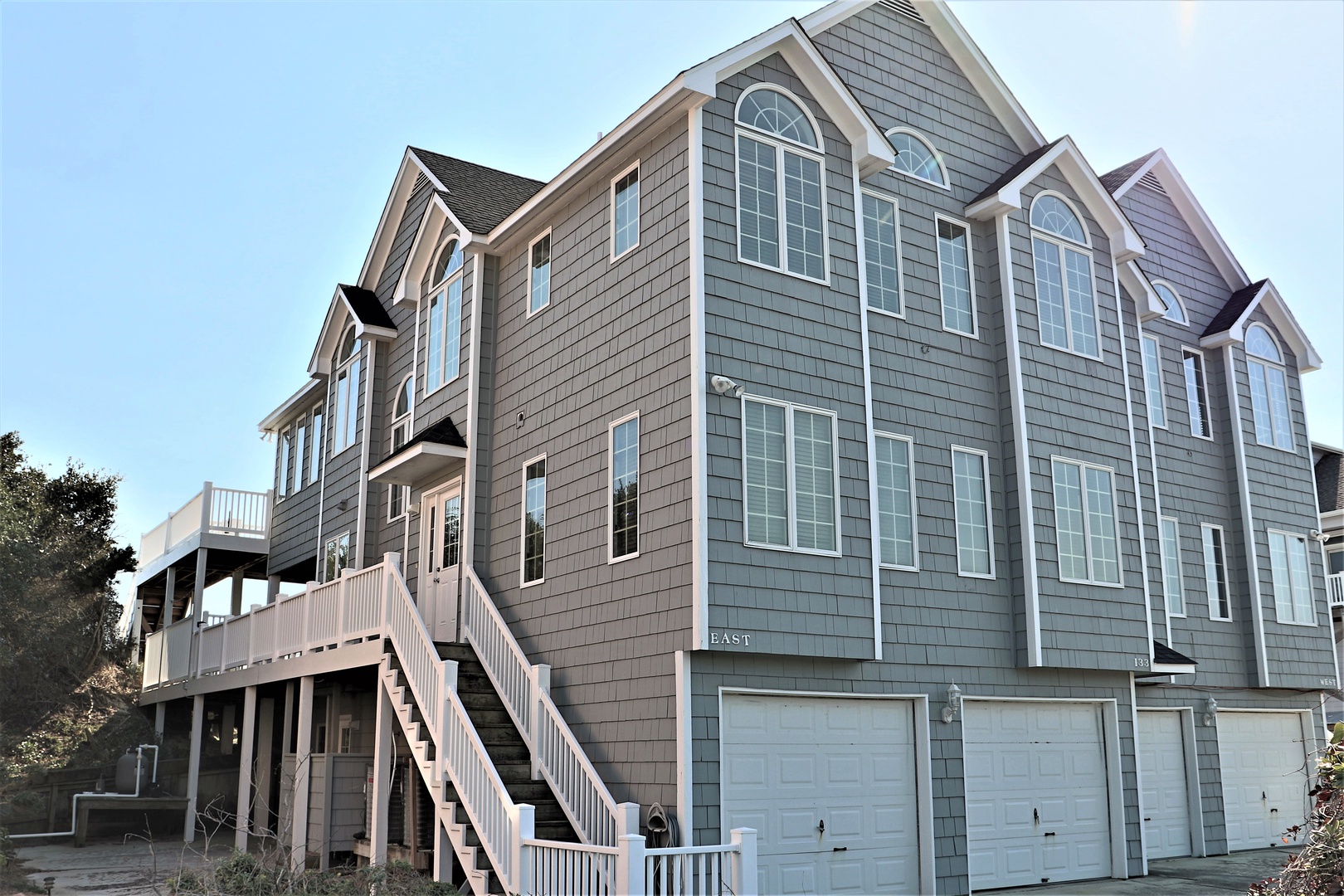 Impressive beachside retreat with elegant shingled architecture and spacious multi-level design welcomes guests to coastal comfort.