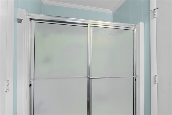 Step into your private ensuite with frosted glass shower doors for complete privacy and relaxation.