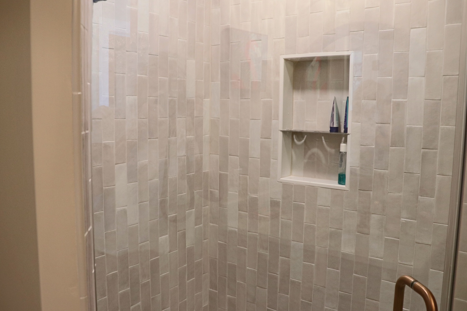 Step into your private spa-like shower with elegant subway tile walls and convenient built-in storage niche for all your essentials.