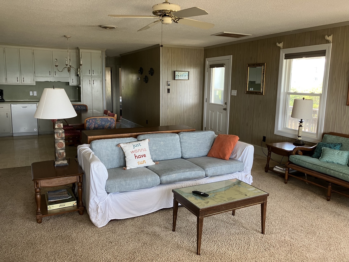 Relax in your cozy living room with soft seating and charming details like the 'just wanna have sun' pillow, perfect for unwinding after beach days.