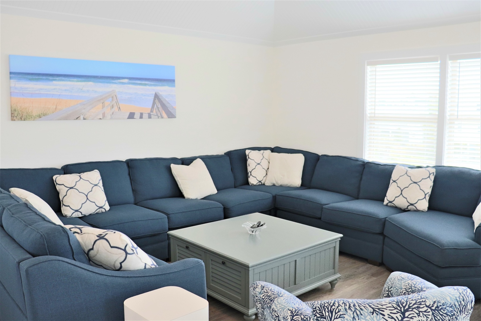 Sink into this spacious sectional sofa where coastal blues meet comfort, perfect for your group gatherings and movie nights.