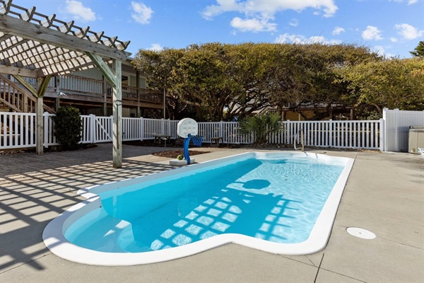 Dive into your private oasis with this sparkling pool, surrounded by shade and coastal charm for perfect relaxation.