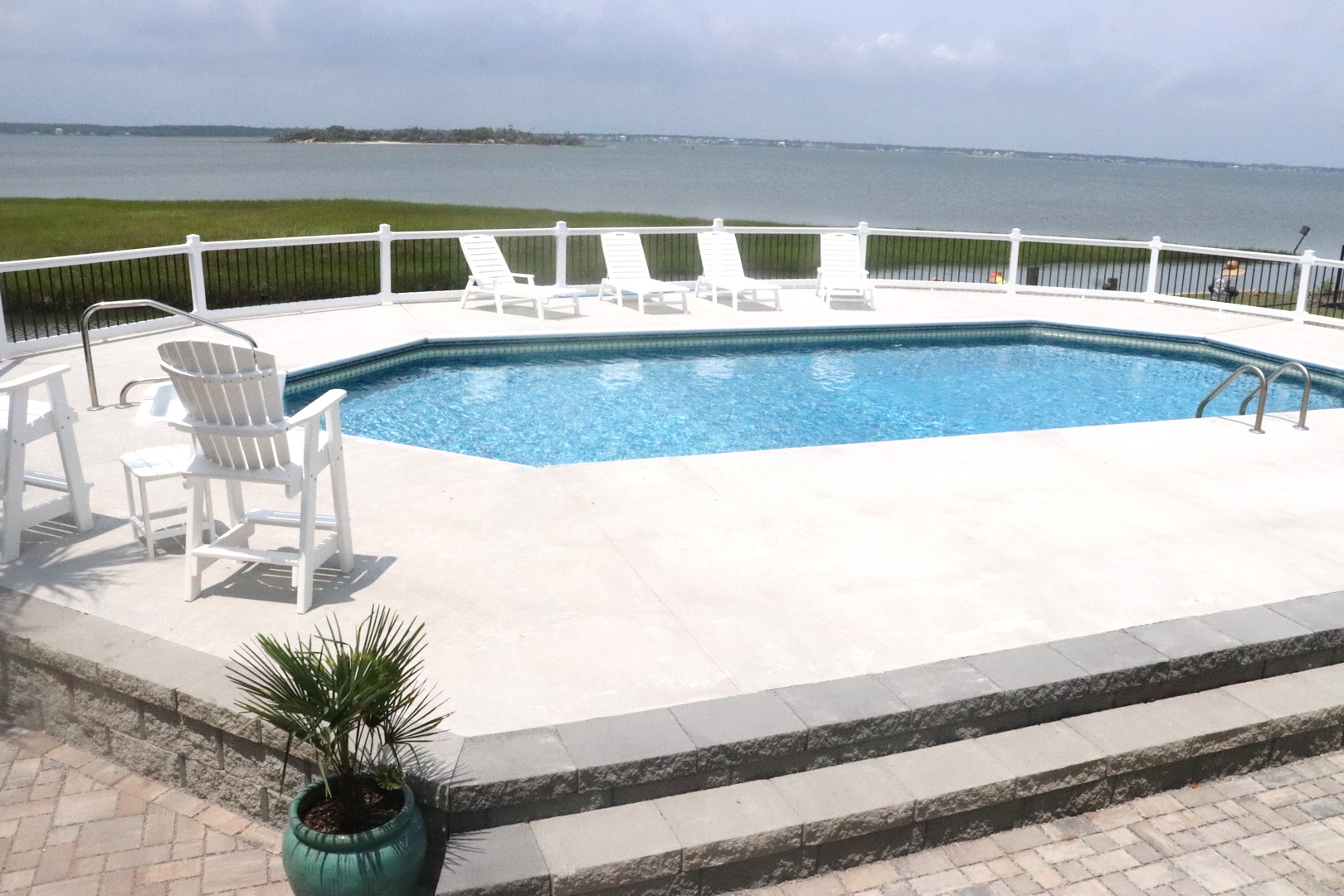 Your private waterfront pool awaits with stunning lake views and comfortable loungers for endless relaxation.