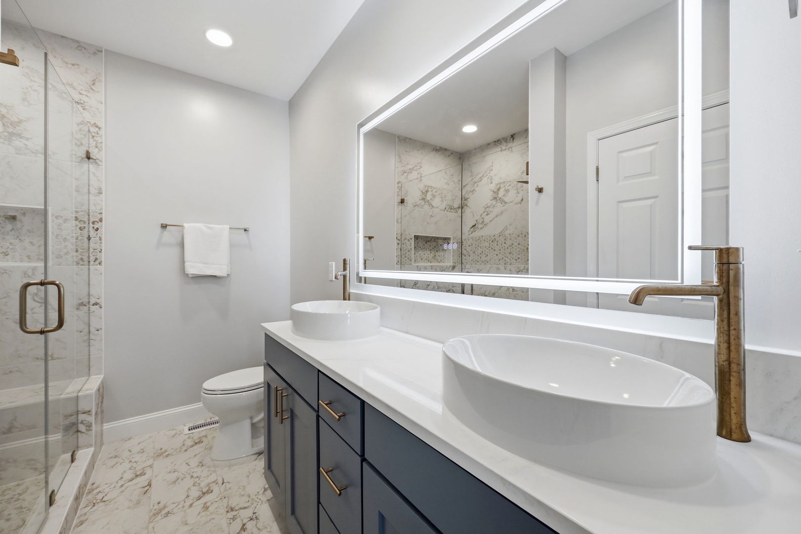 Step into your serene spa-like bathroom with elegant marble, a soaking tub for unwinding, and a glass-enclosed shower inviting peaceful mornings.
