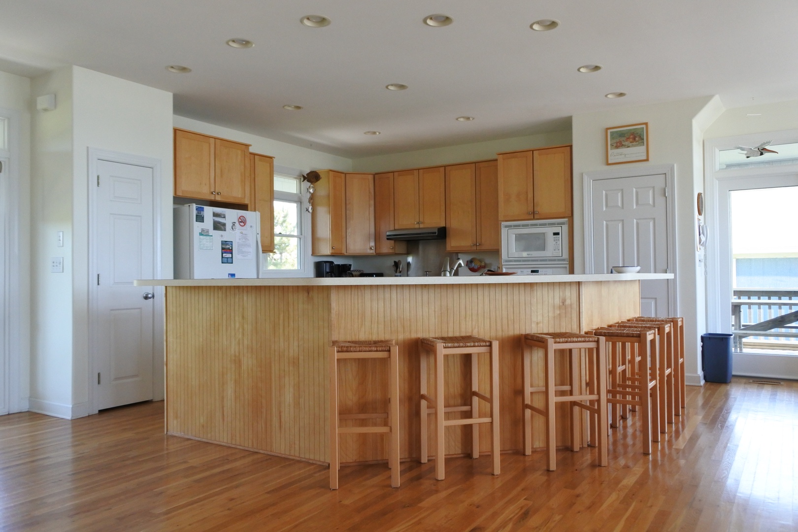 Your spacious kitchen offers everything you need to prepare meals, with a large island for gathering and warm wood finishes throughout.