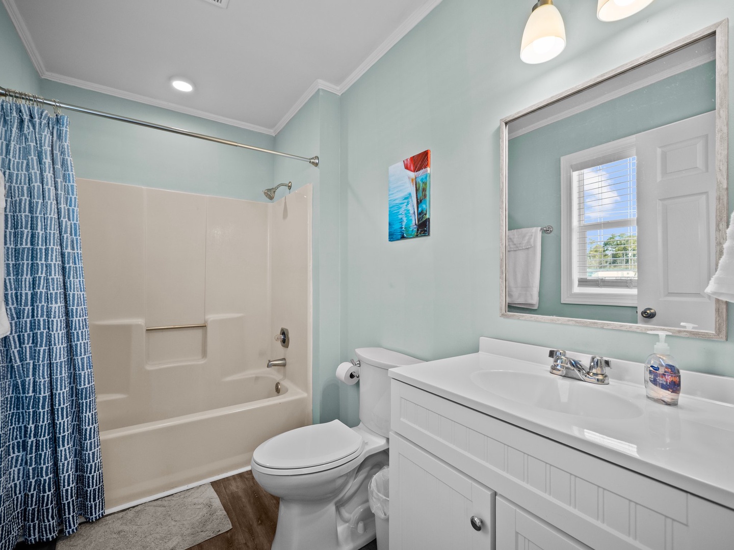 Refresh in your coastal-themed bathroom with soothing mint walls and a spacious tub for relaxing soaks.