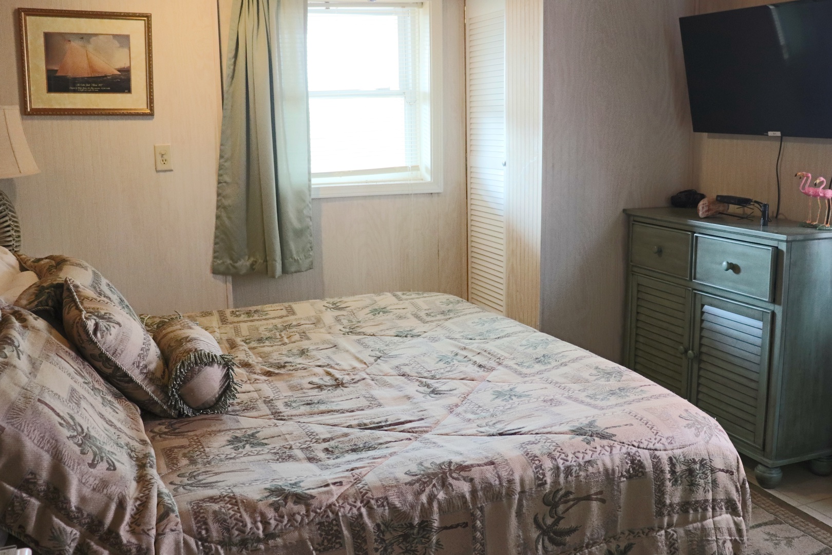 Your peaceful bedroom features a comfortable bed with charming coastal-themed linens, vintage nautical artwork, and all the amenities you need for a relaxing stay.