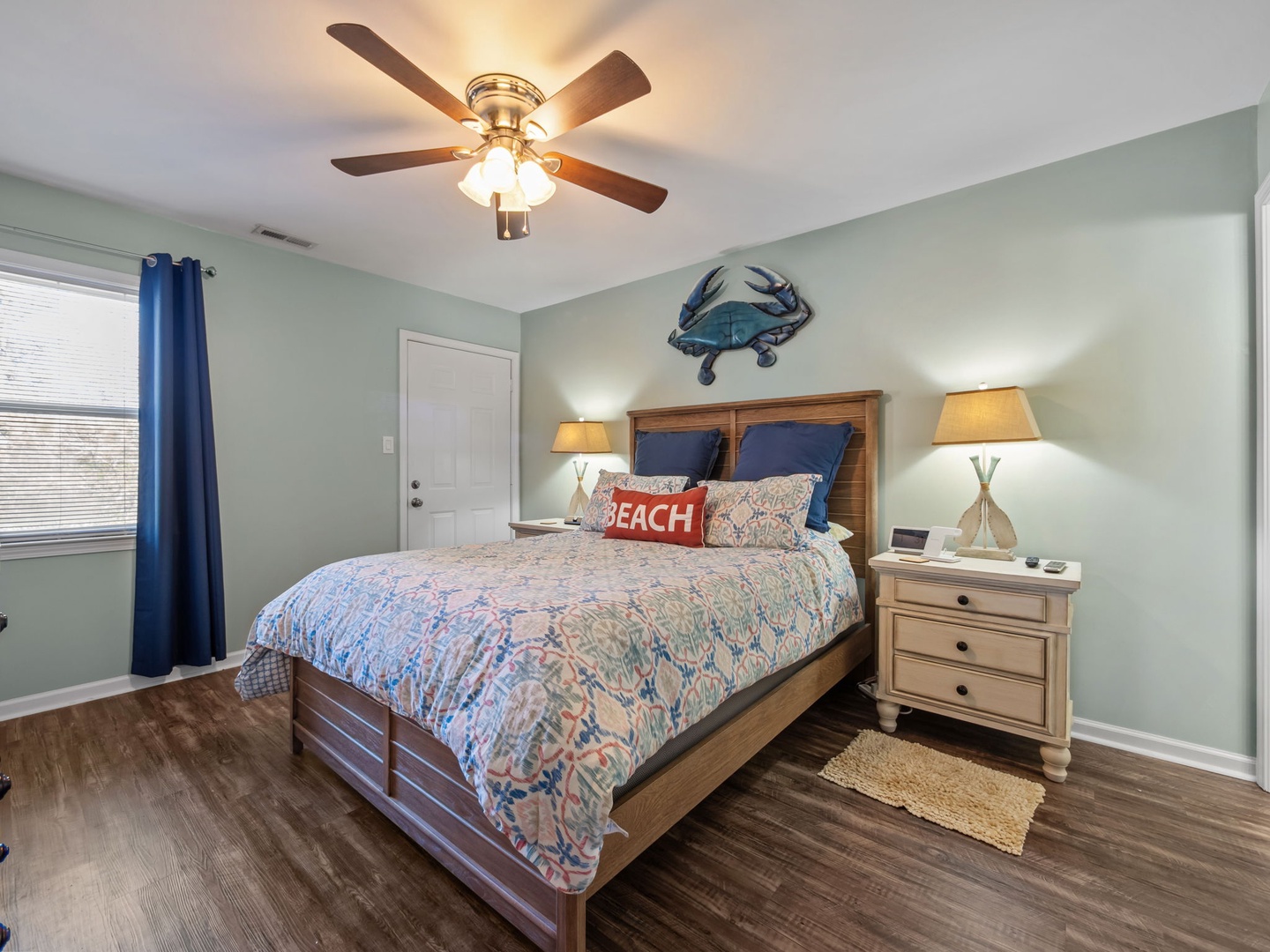 Unwind in your coastal-themed bedroom with charming nautical touches, soft lighting, and a ceiling fan for perfect comfort year-round.