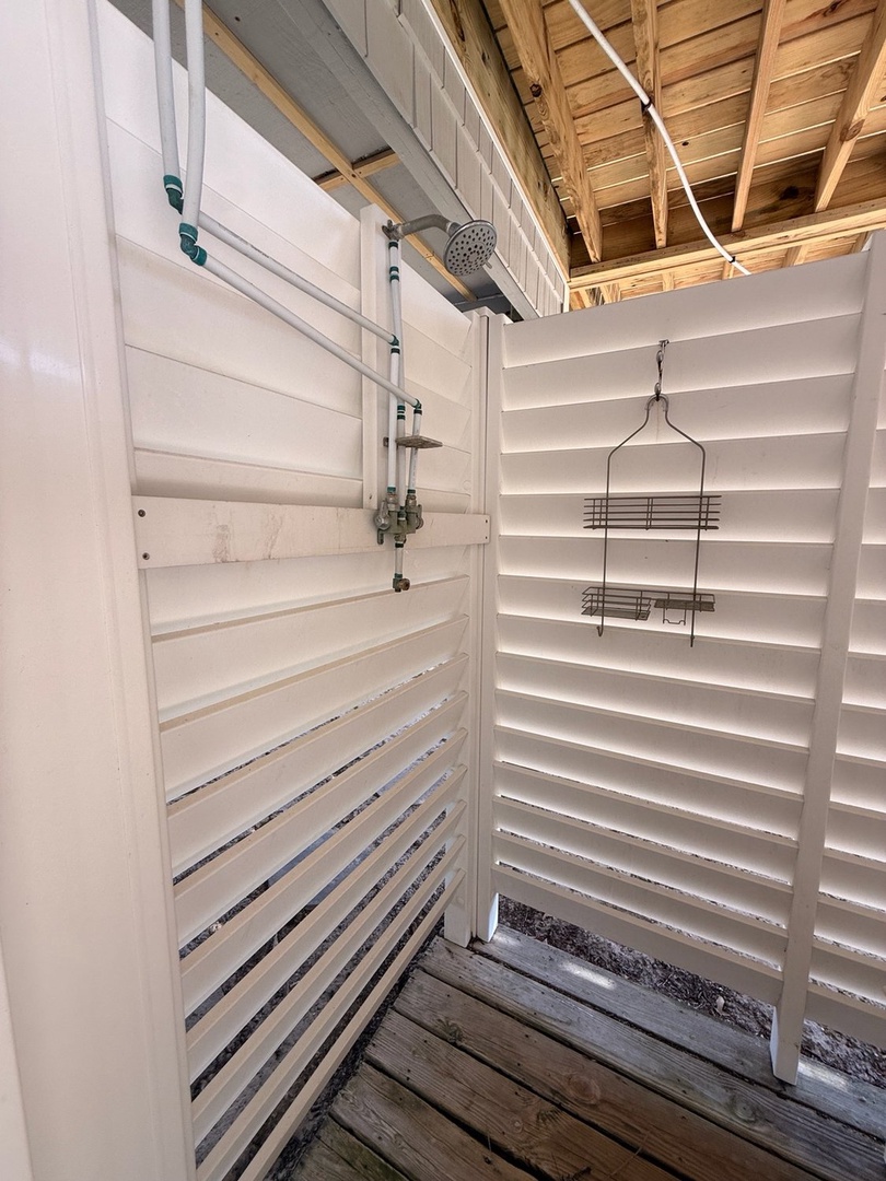 Step into your own private outdoor shower, where warm water and fresh air blend for a refreshing escape. Let sunshine filter through slatted walls as you rinse off after a day of adventure.