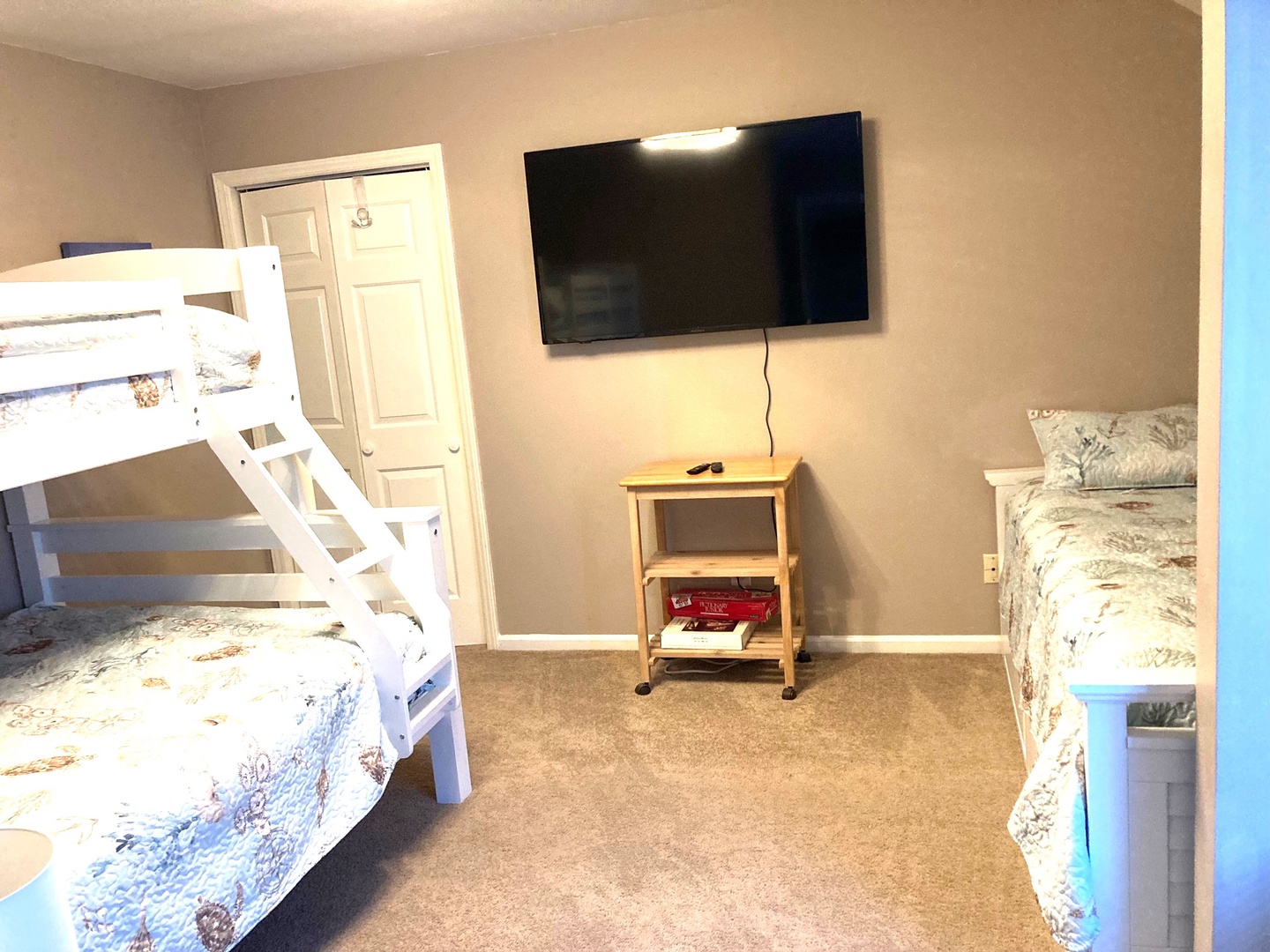 Your family's perfect sleep haven with twin beds and bunk bed, plus a big-screen TV for cozy movie nights together.