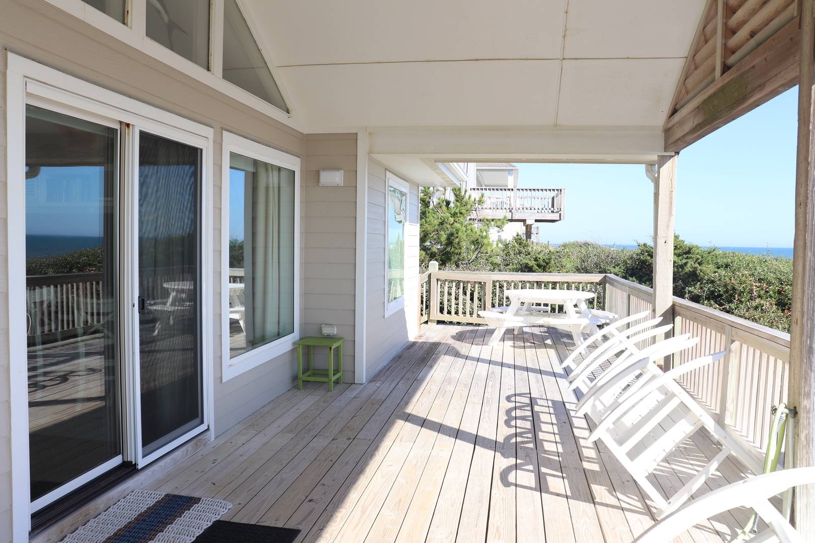 Relax on your private deck with ocean glimpses, where white chairs await your morning coffee and evening sunsets.