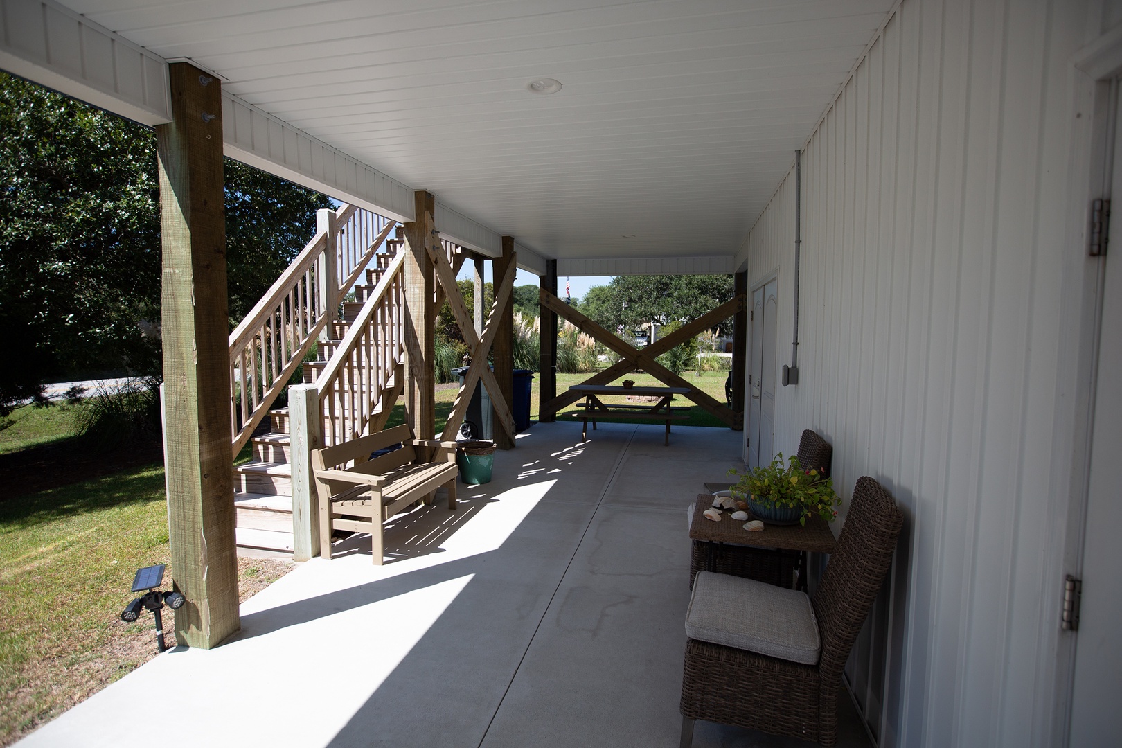 Your peaceful covered porch offers shaded seating where you can unwind with morning coffee or evening conversations.