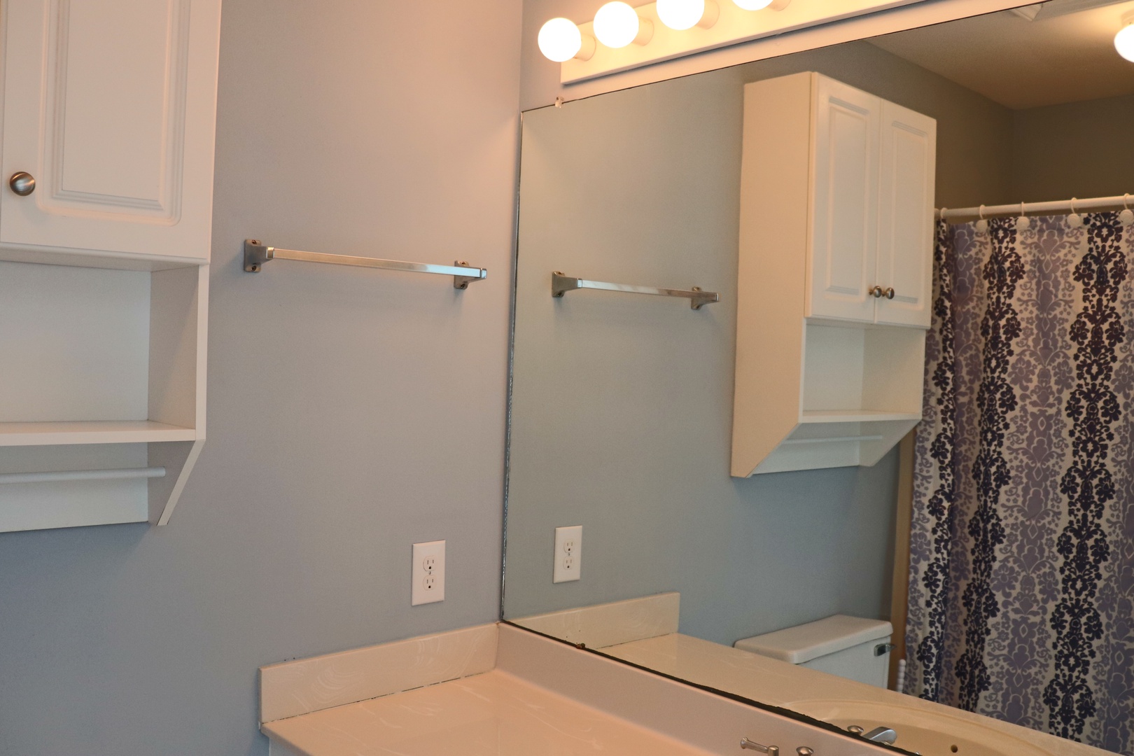 Step into your private bathroom featuring ample vanity space, bright lighting, and thoughtful storage to make your morning routine effortless.