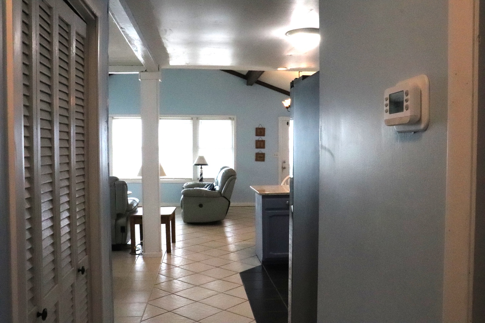 Open, airy living space with comfortable seating, dining area, and beachy coastal charm perfect for relaxing after a day of exploring.