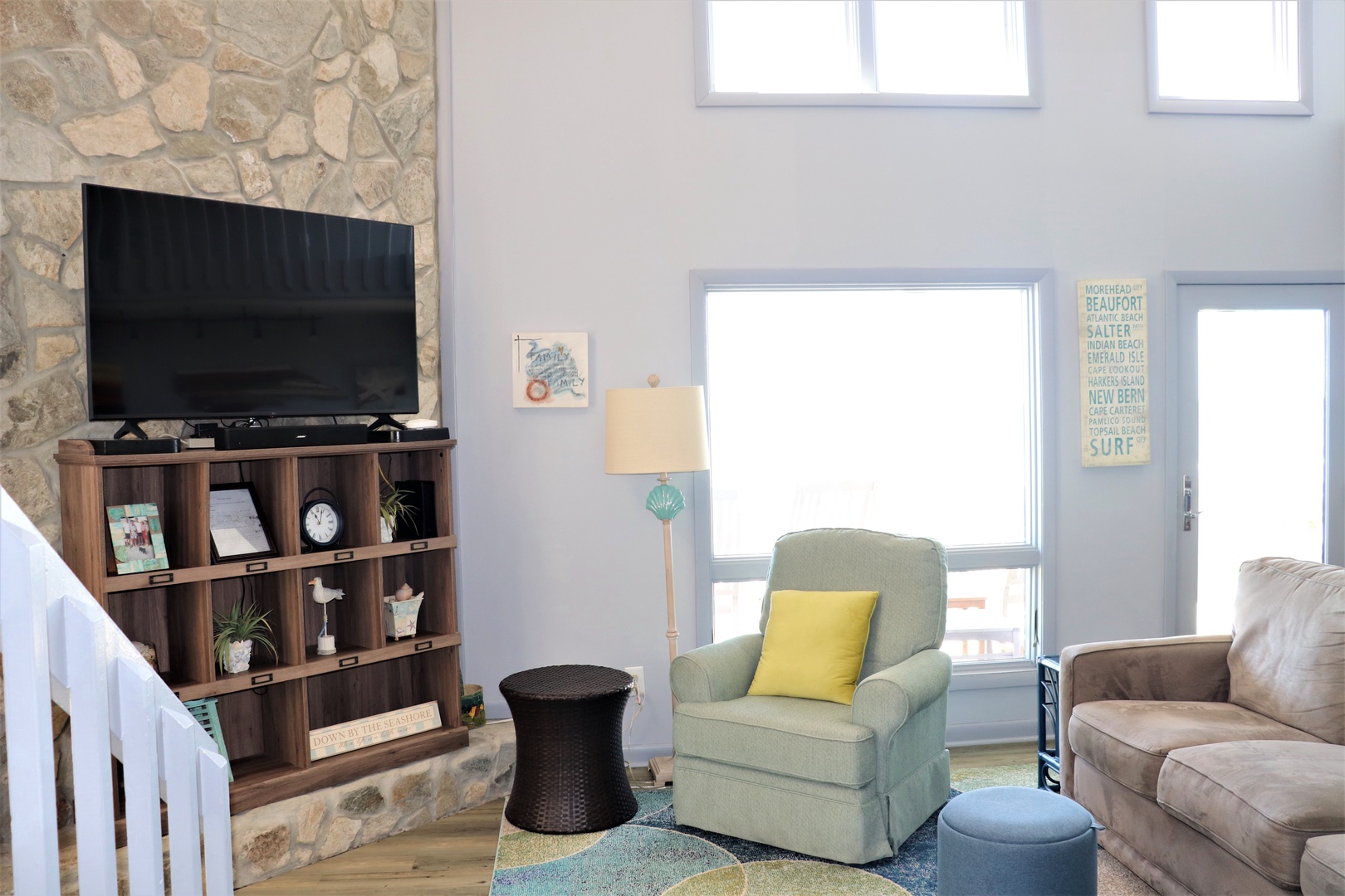 Relax in your bright living space with cozy seating and modern entertainment, perfect for unwinding after coastal adventures.