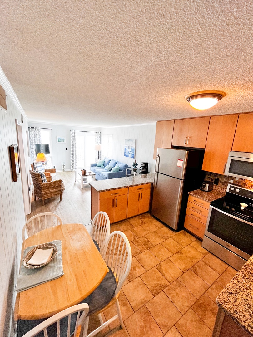 Your open-concept space flows beautifully from the fully equipped kitchen to the comfortable living area, perfect for cooking together and relaxing.