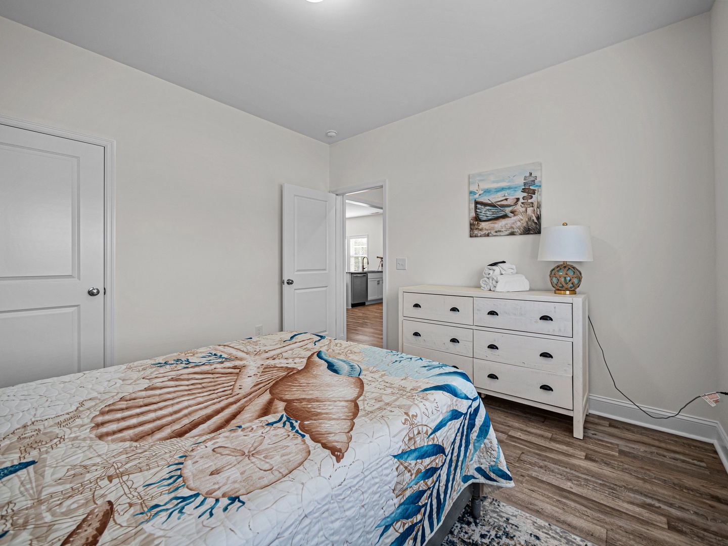 Your peaceful bedroom features ocean-themed bedding and coastal artwork, creating a serene retreat for restful nights.