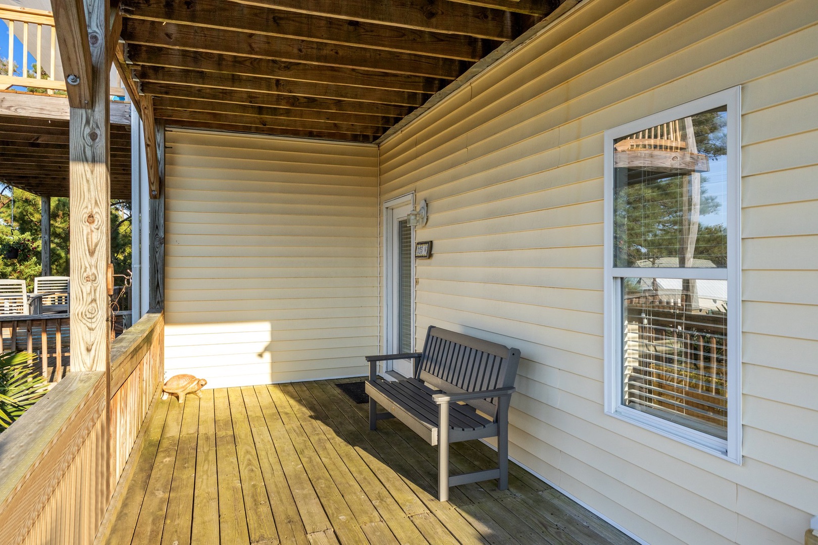 Your peaceful covered porch offers the perfect spot to unwind on comfortable seating while enjoying natural light and serene views.