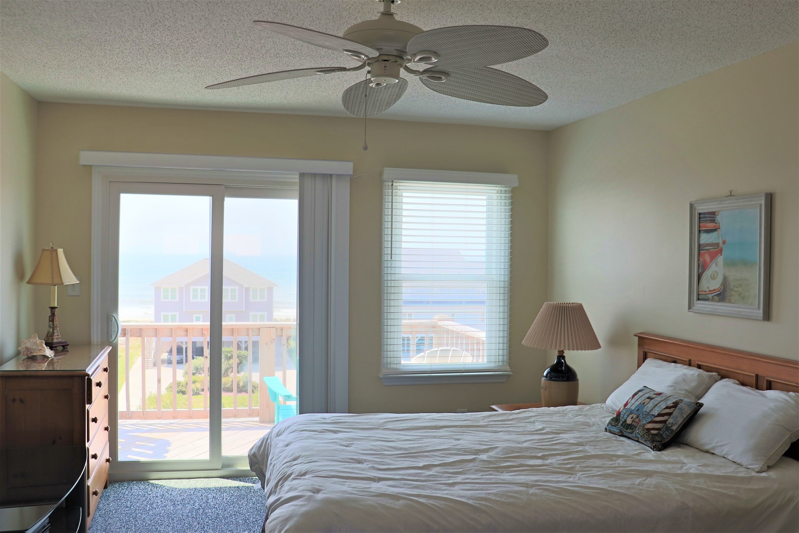 Your coastal bedroom features a king bed and sliding door to your private balcony. Ocean breezes flow through as you relax.