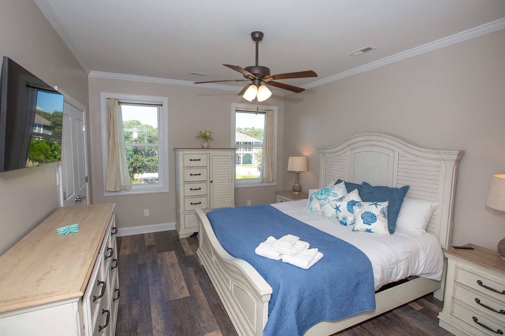 Relax in your coastal-themed bedroom with nautical accents, plush bedding, and peaceful neighborhood views from dual windows.