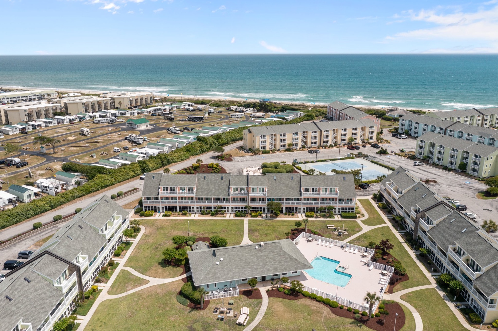 Coastal vacation community featuring modern apartment buildings, swimming pool, and direct beach access just steps from the Atlantic Ocean.