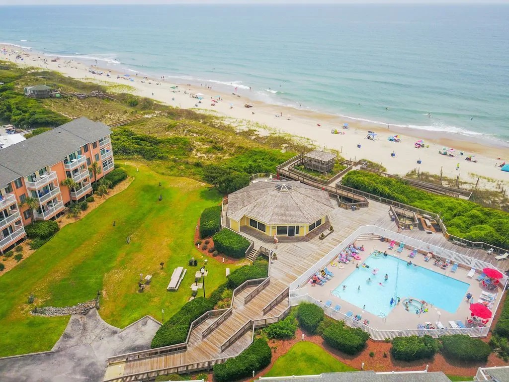 Oceanfront resort featuring pool, beach access, and scenic coastal setting with pristine sandy shores and crystal-clear waters.