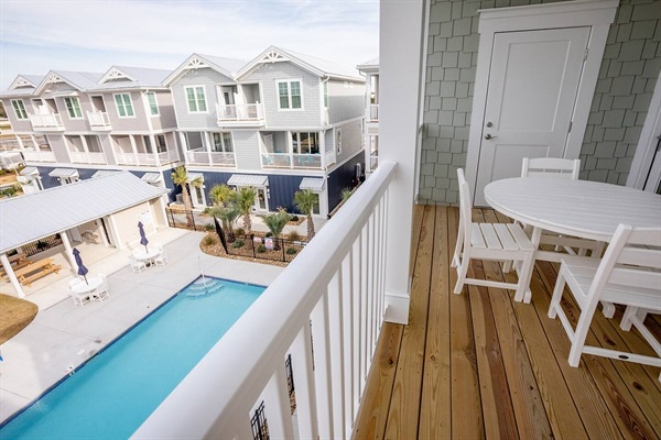 Your private balcony overlooks the sparkling pool and courtyard, where you'll sip morning coffee at your bistro table.