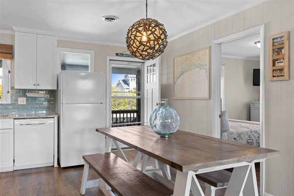 Your bright dining space features a beautiful wooden table perfect for morning coffee or evening meals with loved ones.