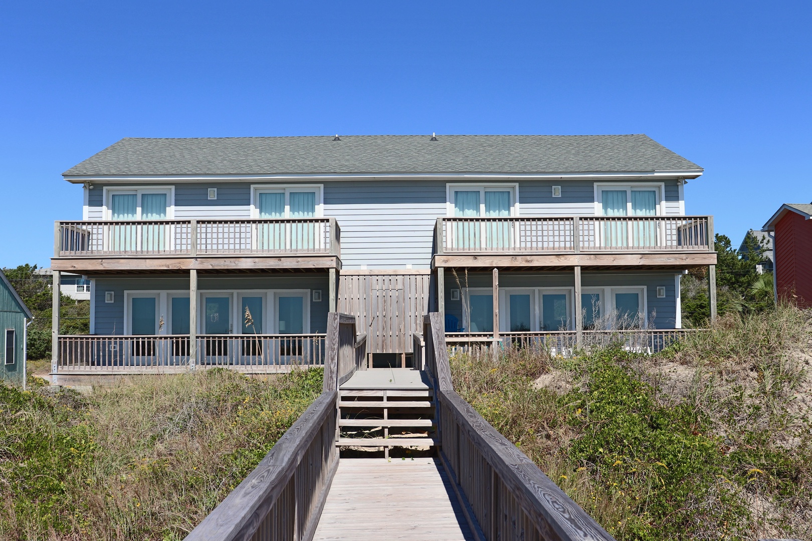 Coastal duplex featuring oceanfront access with private boardwalk leading directly to your beachside retreat.