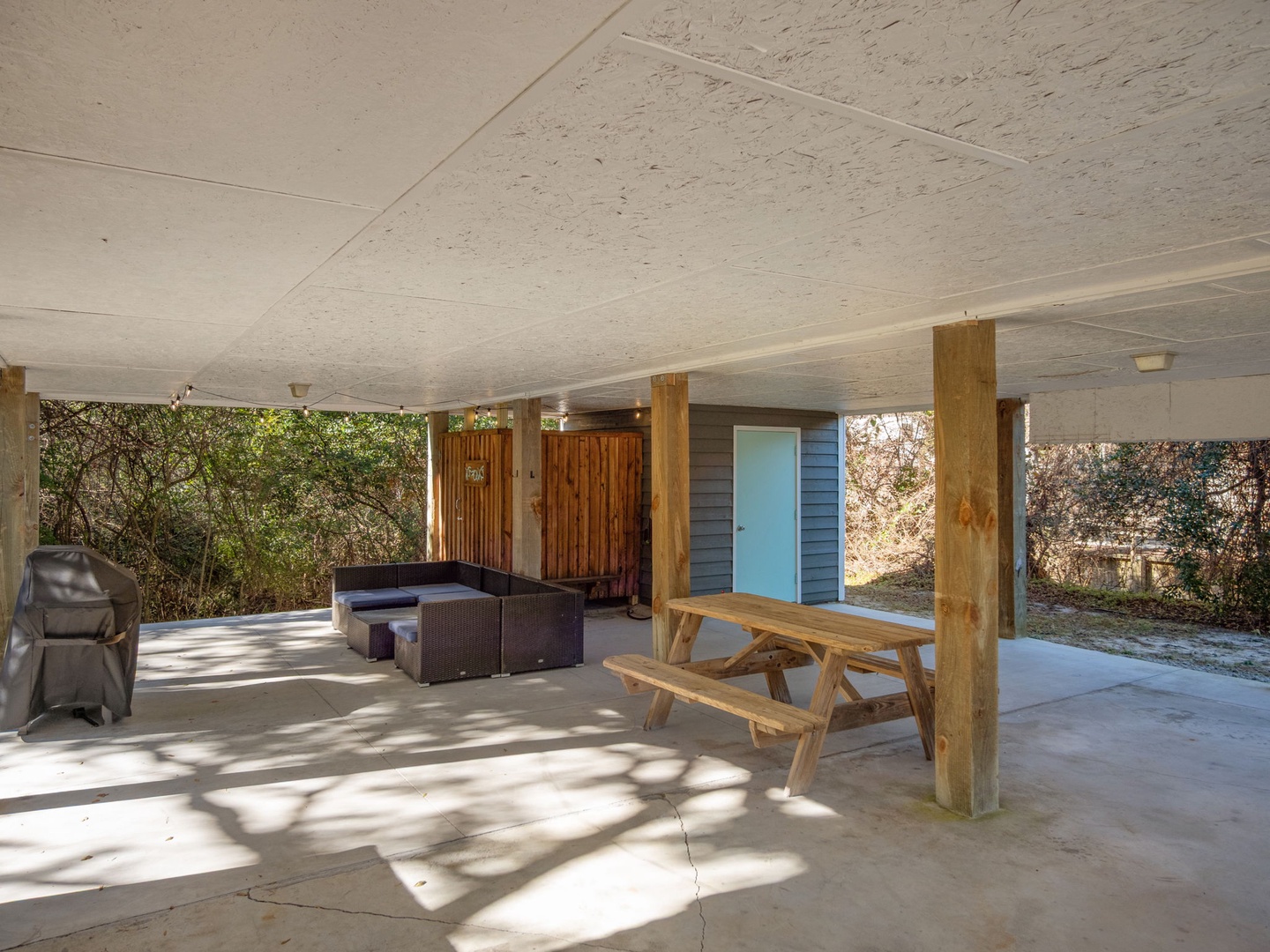 Your covered outdoor space features a picnic table and BBQ area, perfect for cooking and dining al fresco while staying shaded.