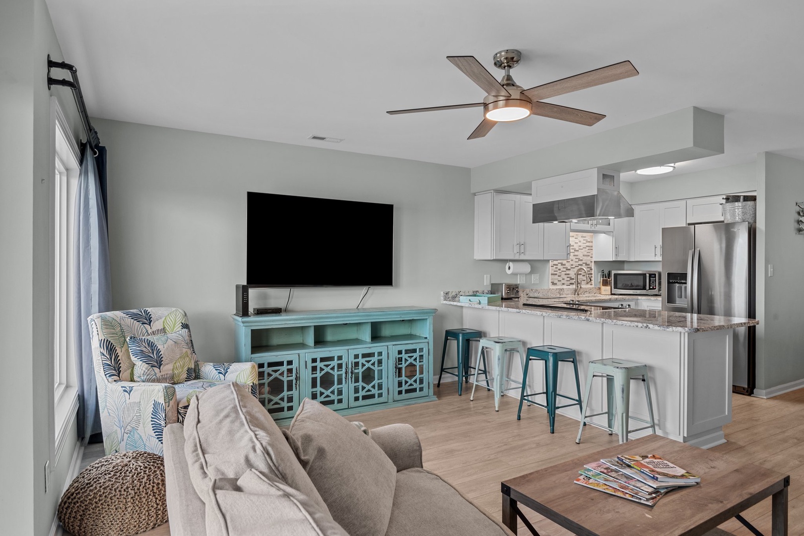 Relax in your bright open-plan living space with modern kitchen, comfy seating, and coastal-inspired touches throughout.