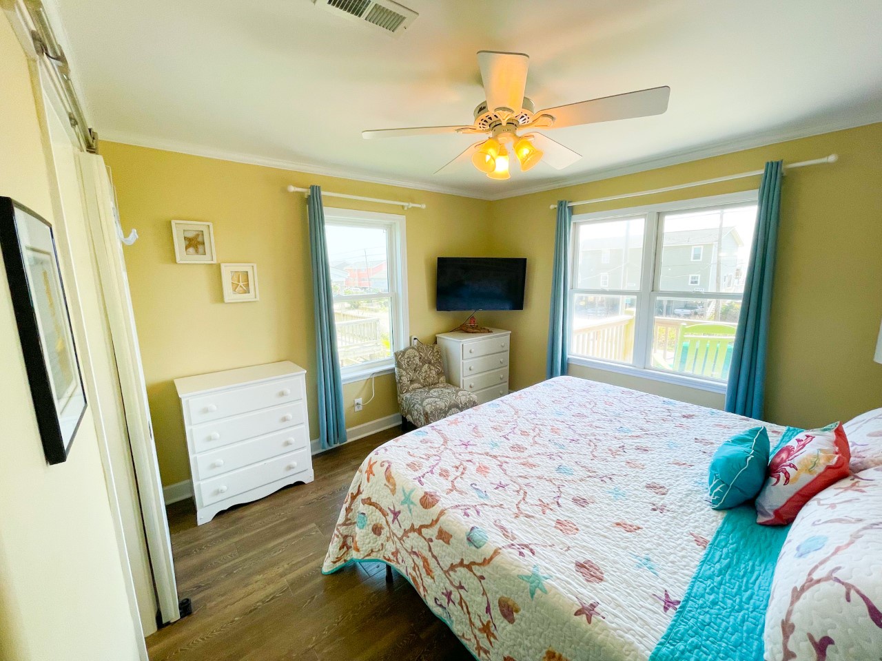 Drift off to sleep in this cheerful bedroom with sunny walls, ocean-themed bedding, and views of the neighborhood.