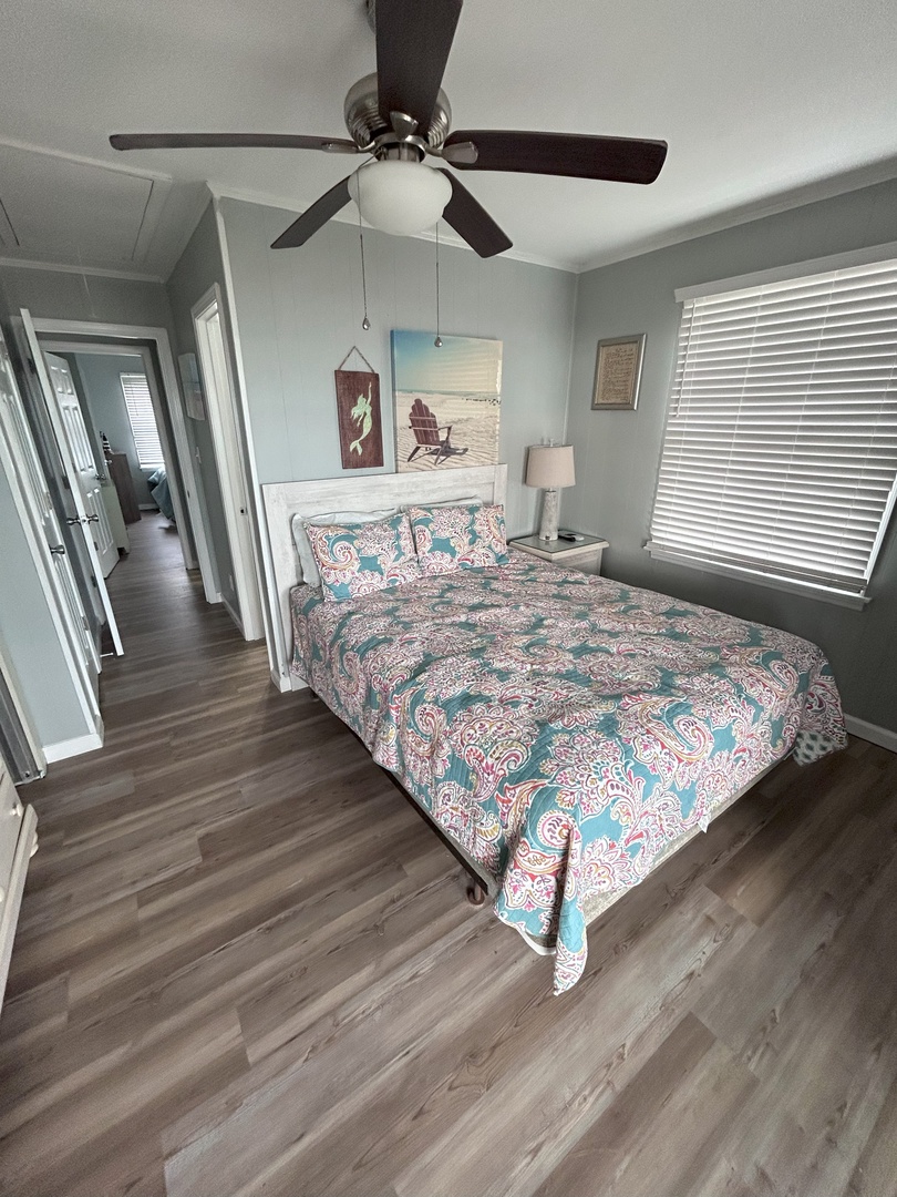 Drift off to peaceful sleep in your cozy bedroom with soft coastal colors, comfortable bedding, and gentle ceiling fan breeze.