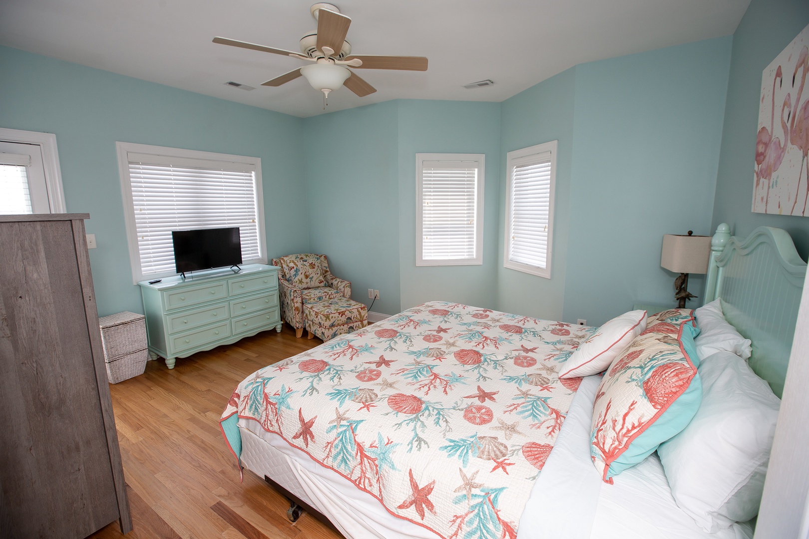 Drift off in your coastal-themed bedroom with ocean-inspired linens and soothing turquoise walls that create the perfect seaside sanctuary.