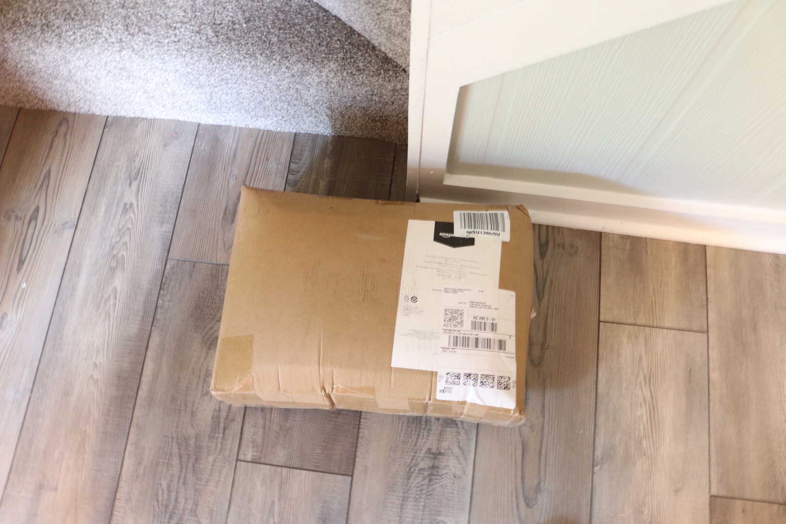 Your package waits safely by the door, ready for your arrival after your travels.