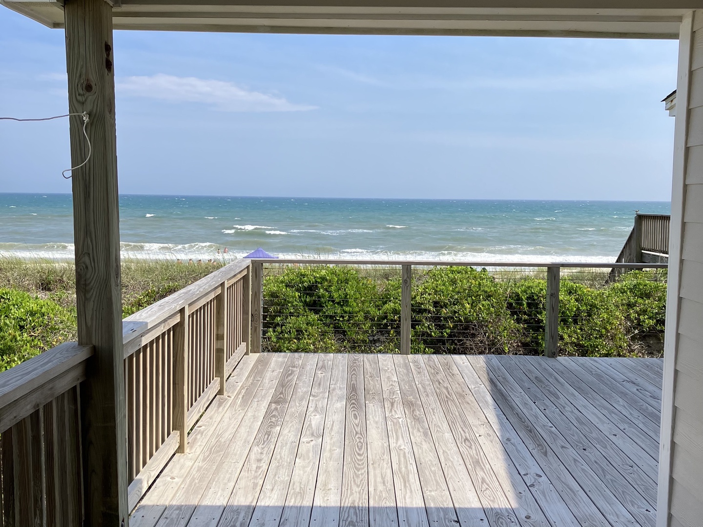 Step onto your private deck and breathe in the ocean breeze while watching waves dance along the sandy shore just steps away.
