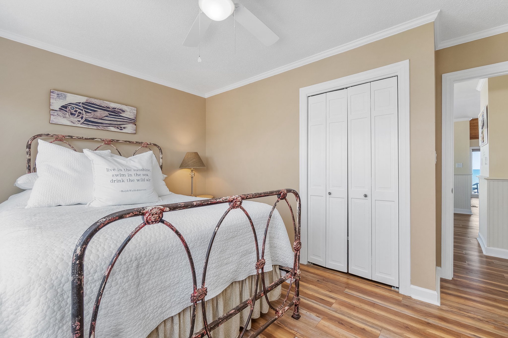 Your charming bedroom features a vintage iron bed with crisp linens and thoughtful coastal touches for peaceful seaside dreams.