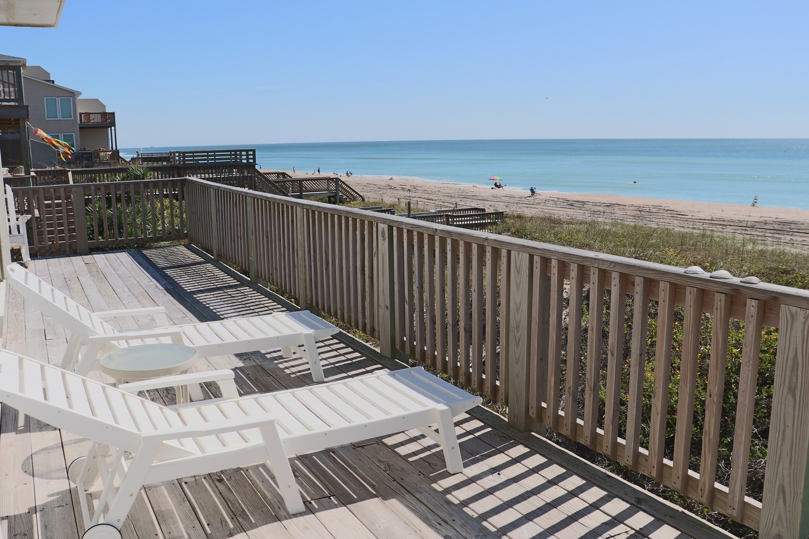Unwind on your private deck with stunning ocean views and direct beach access just steps away.