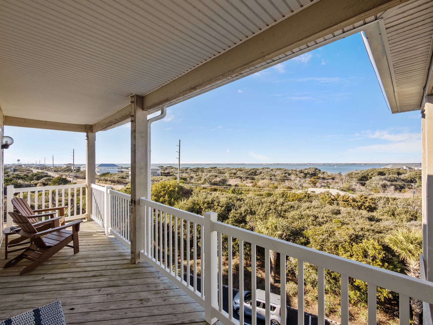Unwind on your private covered balcony with coastal views stretching to the horizon while gentle breezes flow through this peaceful retreat.