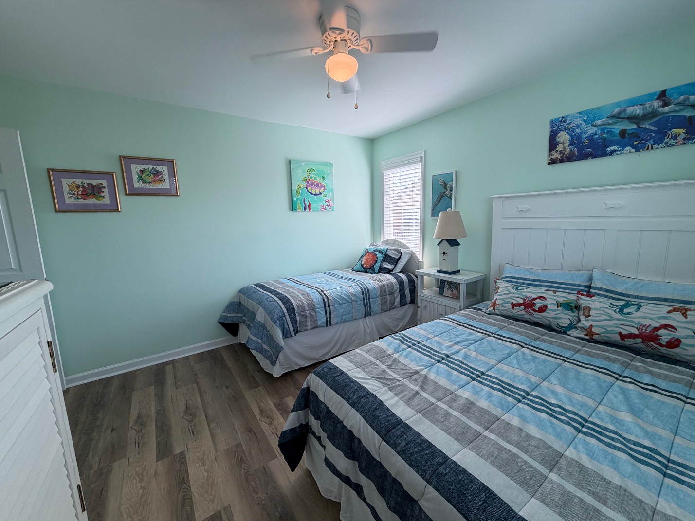 You'll love this cheerful twin bedroom with ocean-themed artwork and coastal charm throughout your stay.