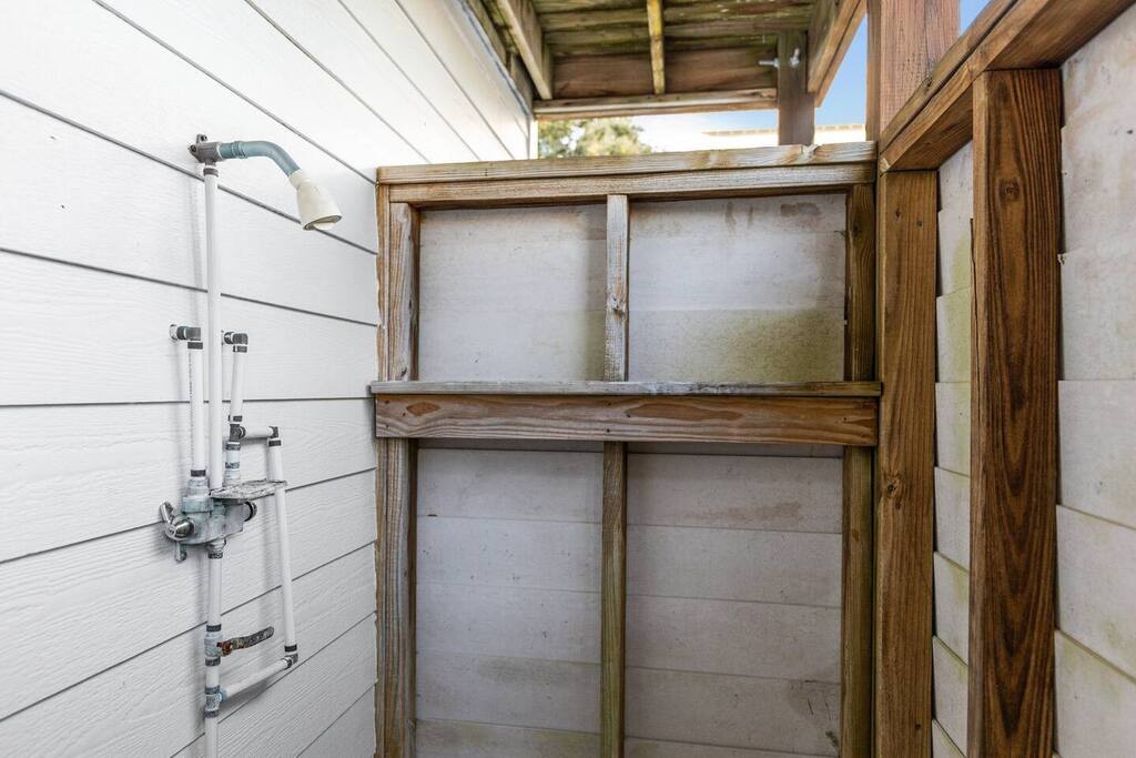 Rinse off in your private outdoor shower, surrounded by natural wood and open sky for a refreshing al fresco bathing experience.