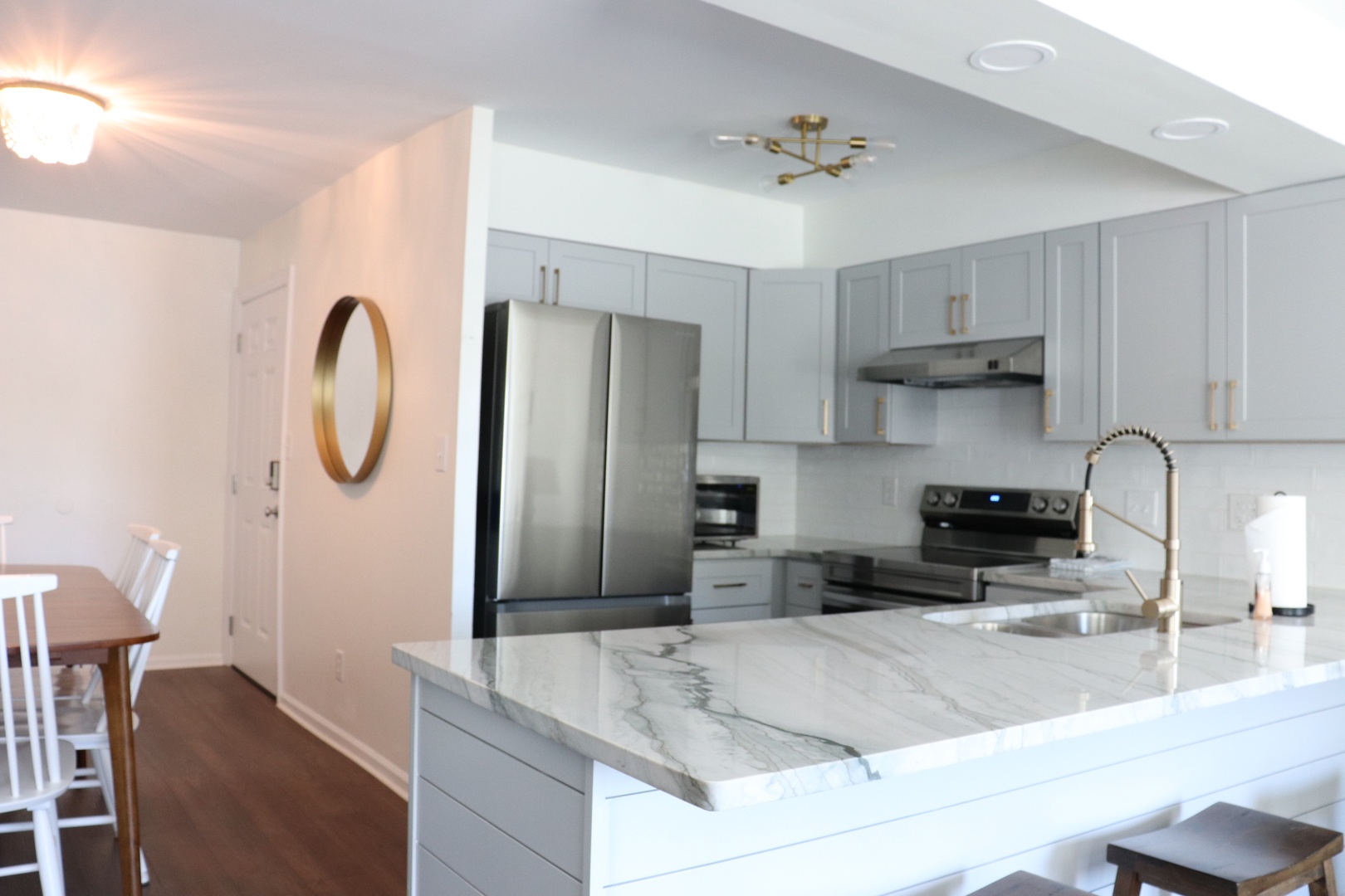 Your modern kitchen awaits with marble counters, stainless appliances, and open design perfect for preparing memorable meals.
