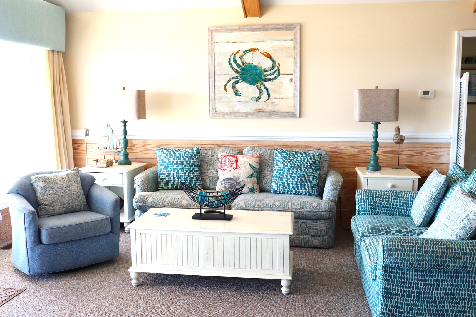 Sink into coastal comfort with turquoise furnishings and nautical artwork creating your perfect seaside retreat.