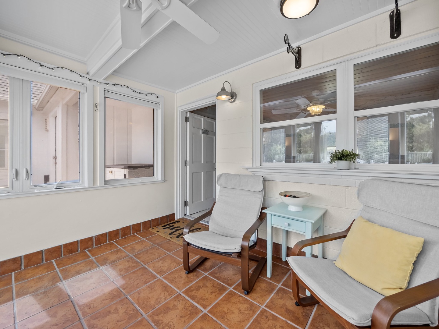 Unwind in your bright sunroom with comfy armchairs and warm terracotta tiles, perfect for morning coffee or quiet reading sessions.