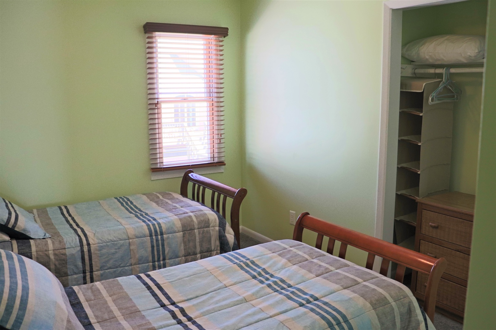 Unwind in this peaceful twin bedroom with soft linens and your own walk-in closet for organized storage.
