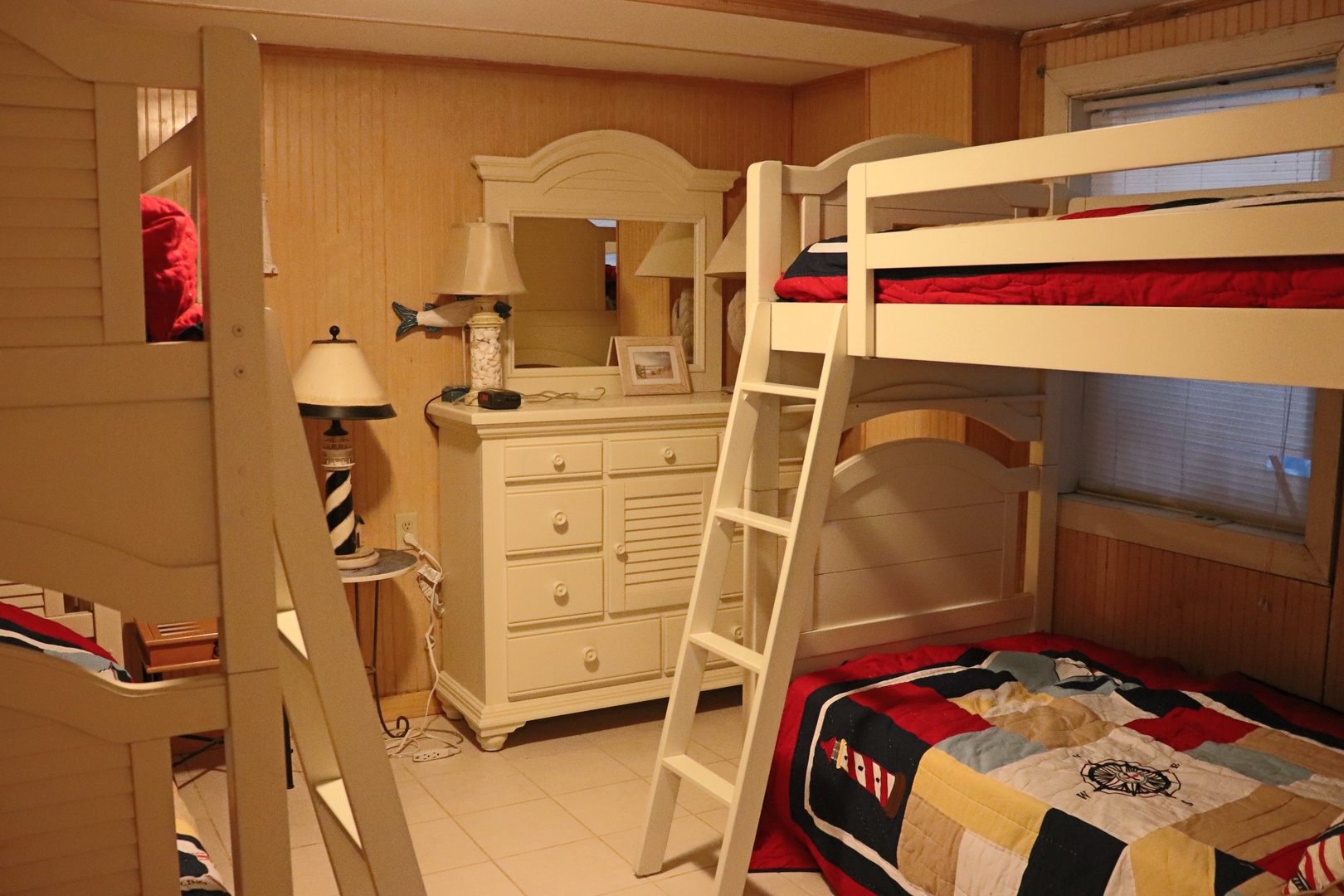 Your kids will love this cozy bunk room with nautical charm and plenty of storage for all their treasures.