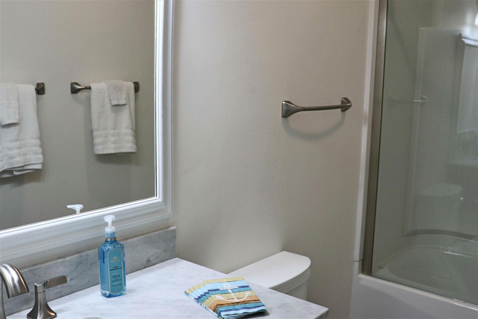 Refresh in your beautifully appointed bathroom with pristine marble countertops, soft towels, and modern fixtures creating the perfect spa-like retreat.