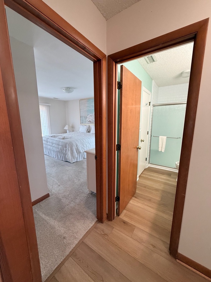 Step into your peaceful retreat—a cozy bedroom and bright bathroom await your arrival, offering comfort and convenience in one inviting space.